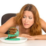 woman craving sugar sweet cookies worried about weight gain